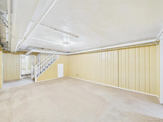 a view of an empty room with stairs