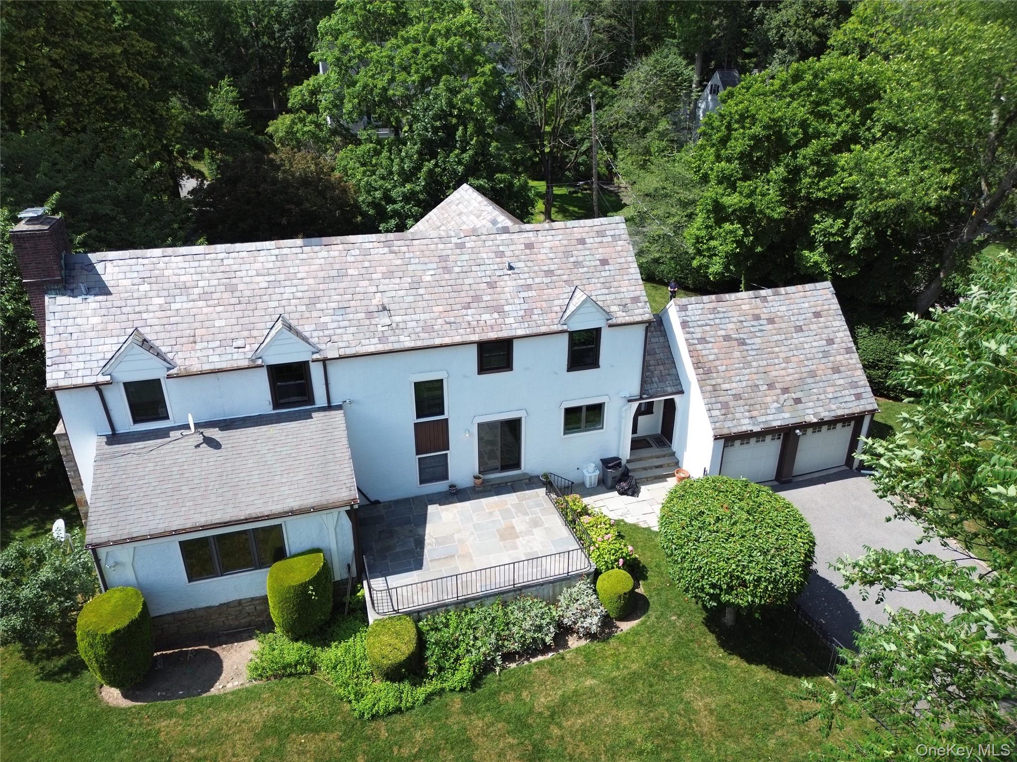 75 Lord Kitchener Road New Rochelle, NY 10804 - Photo 43 of 47 an aerial view of a house with a garden and trees