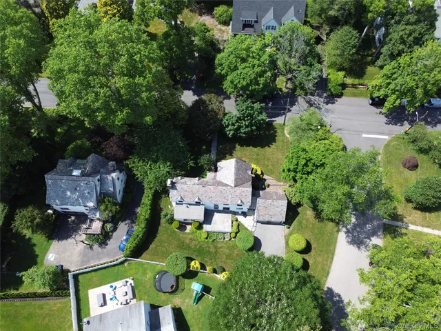 an aerial view of a house with garden space and street view
