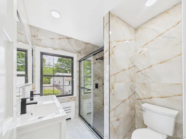 a bathroom with a sink toilet and shower