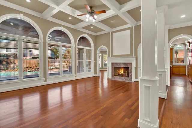a view of empty room with wooden floor and fireplace