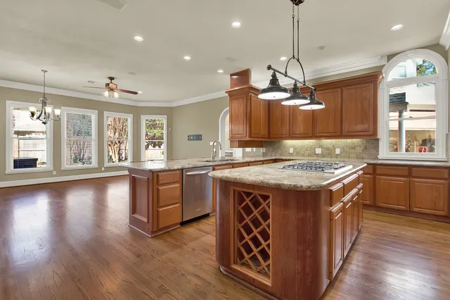 a kitchen with a stove and a wooden floor