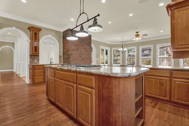 a kitchen with stainless steel appliances granite countertop a sink and a refrigerator