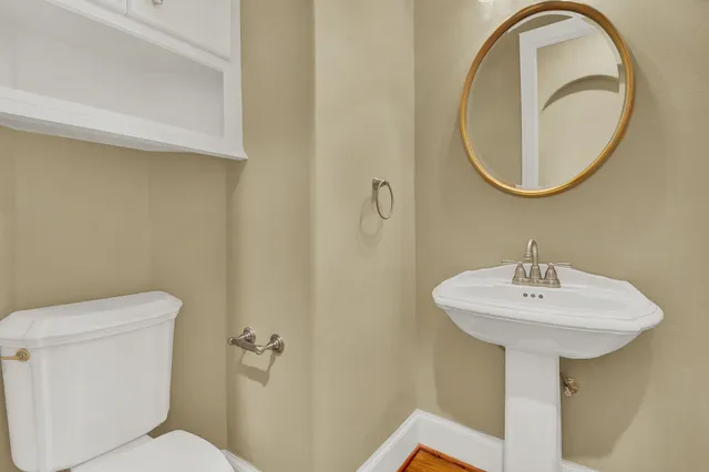 a bathroom with a sink a mirror and a toilet