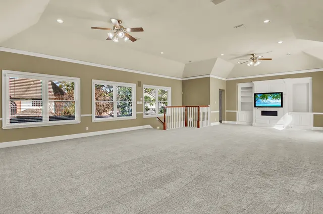 a view of an empty room with a fireplace and a window
