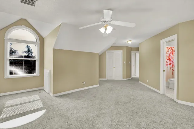 an empty room with windows and closet