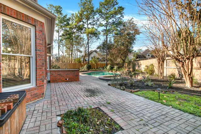 a front view of a house with a yard and potted plants