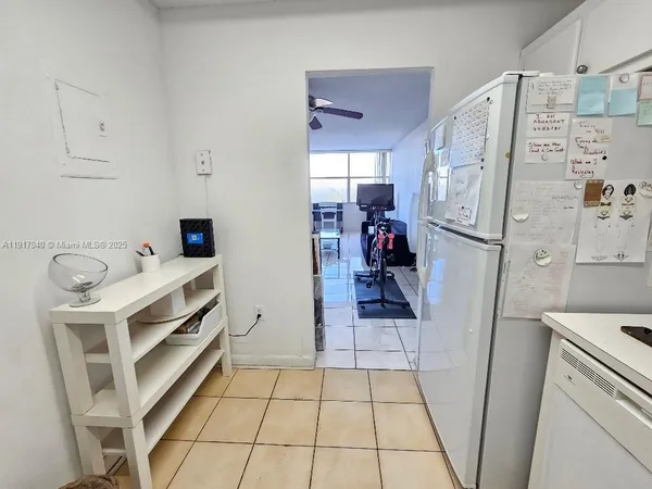 a walk in closet and view of bathroom