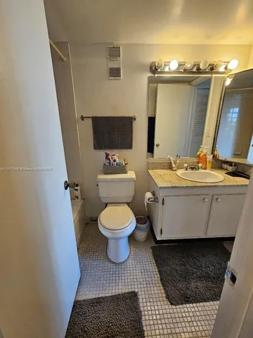 a bathroom with a toilet a sink and a mirror