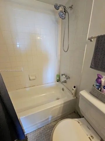 a bathroom with a granite countertop toilet a sink and shower