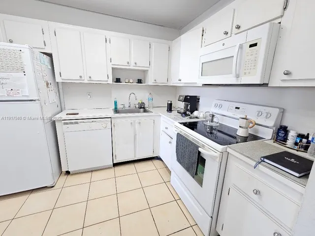 a kitchen with cabinets and appliances