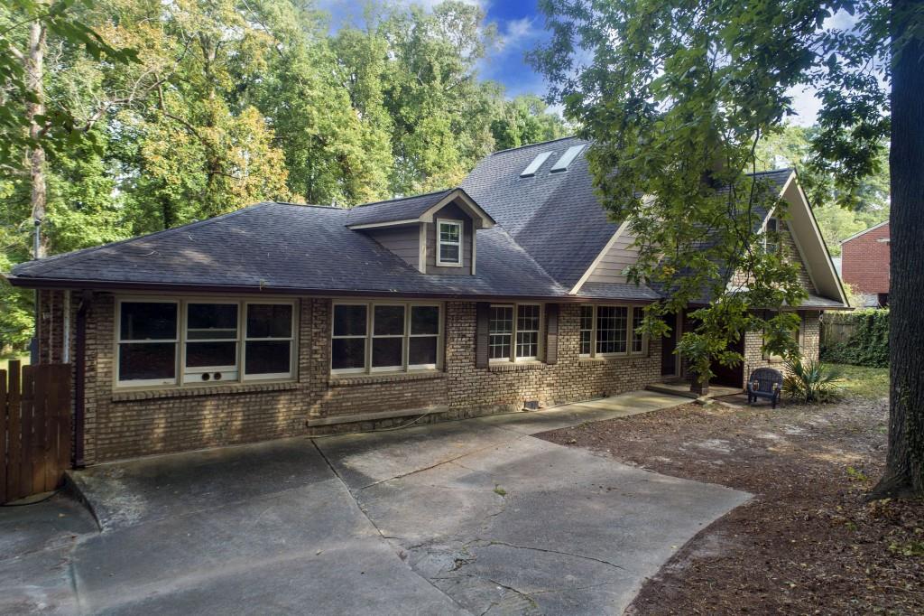 a front view of a house with a garden