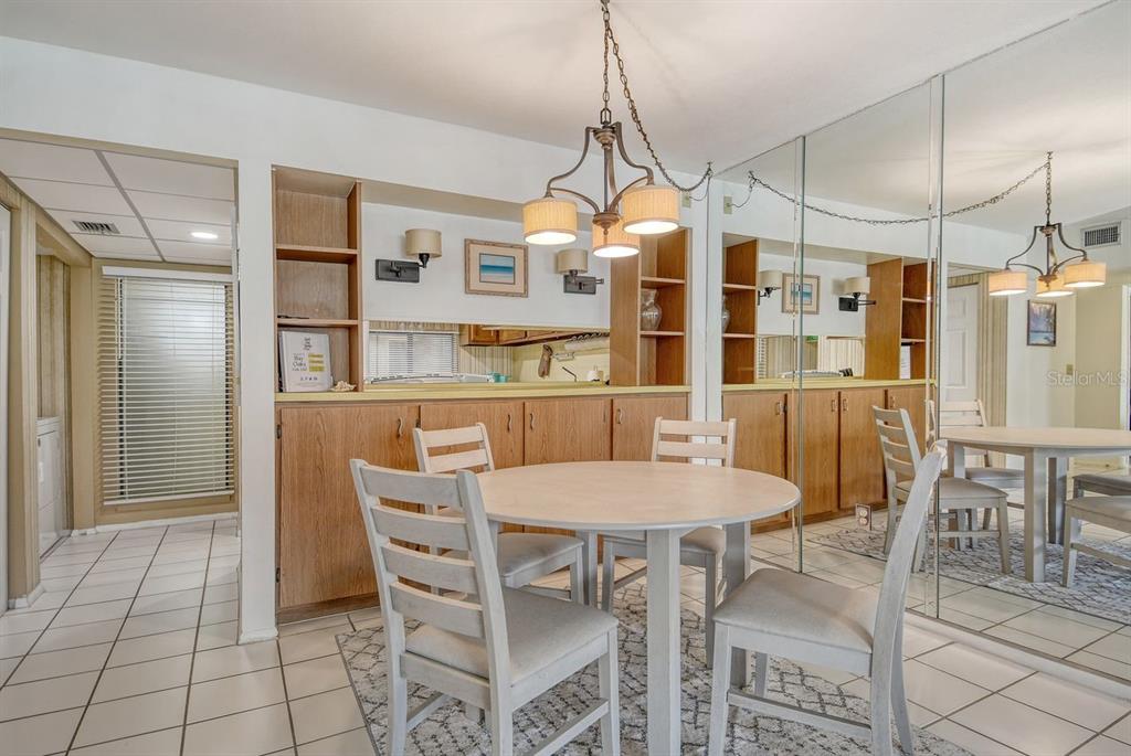 6157 Midnight Pass Road, Unit E63 Sarasota, FL 34242 - Photo 17 of 61 a view of a dining room with furniture