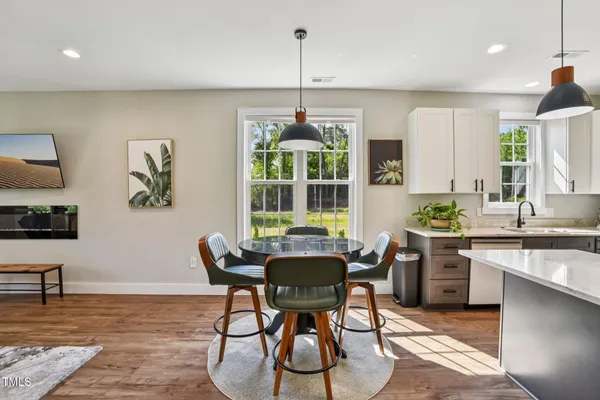 a living room with furniture and view of kitchen