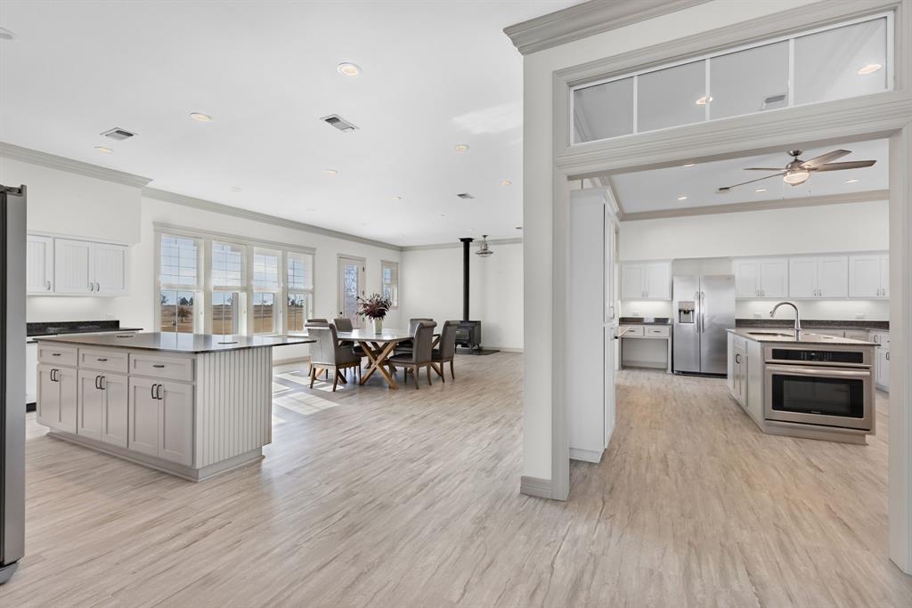 2263 County Road 33040, Unit 4 Brookston, TX 75421 - Photo 19 of 38 a kitchen with sink cabinets and wooden floor