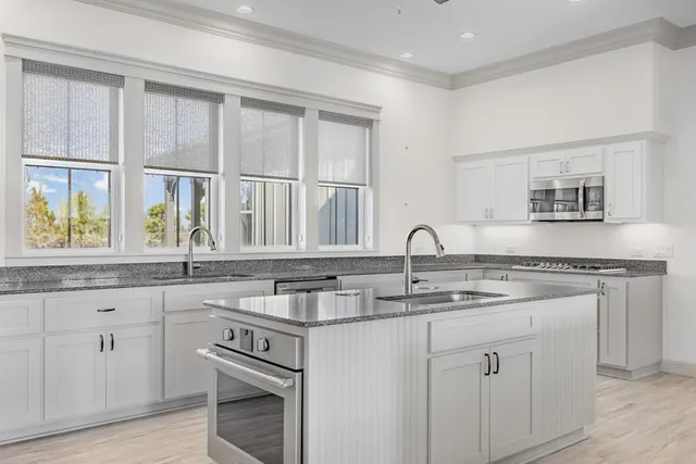 a view of an empty room with a kitchen