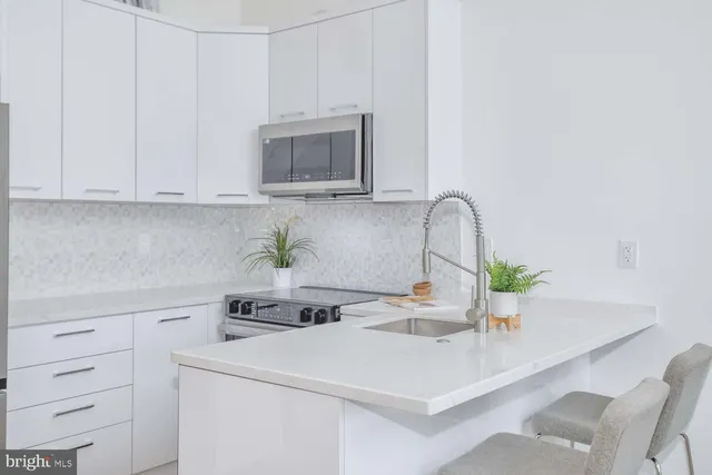 a kitchen with a white cabinets and white appliances