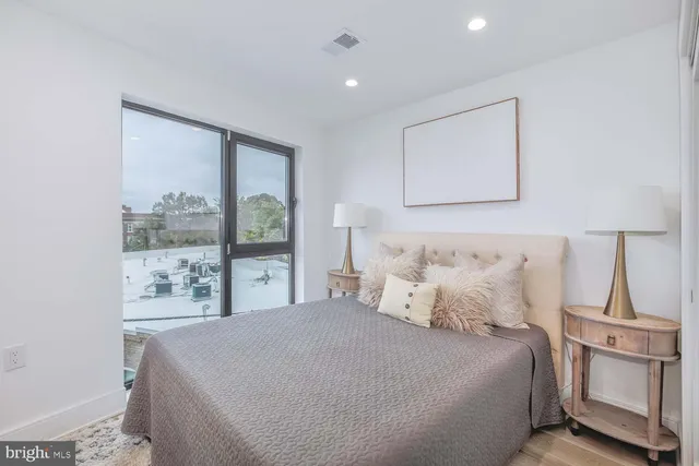 a bedroom with a large bed and a lamp