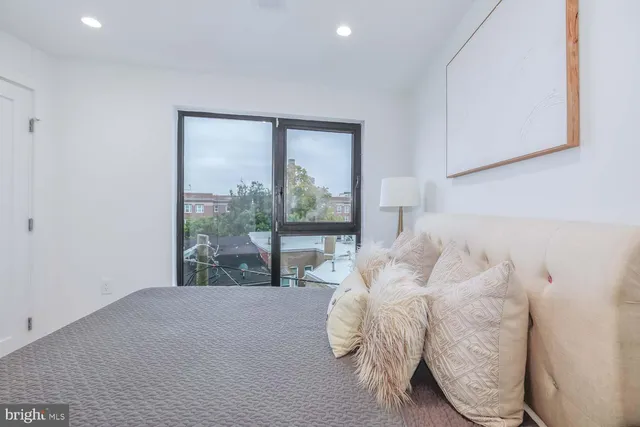 a bed sitting in a bedroom next to a window