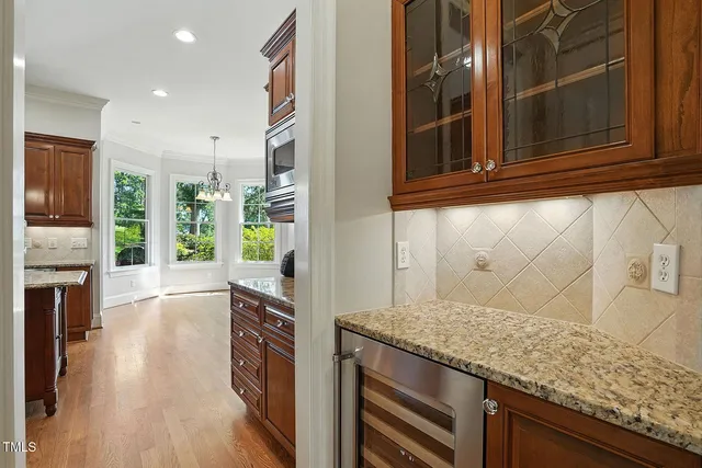 a view of kitchen with kitchen island stainless steel appliances refrigerator stove and oven