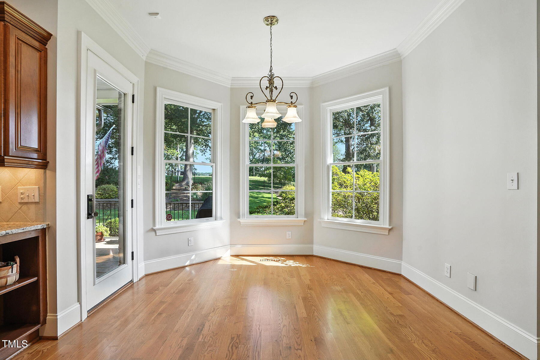 1605 Hunting Ridge Road Raleigh, NC 27615 - Photo 15 of 55 a view of an empty room with wooden floor and a window