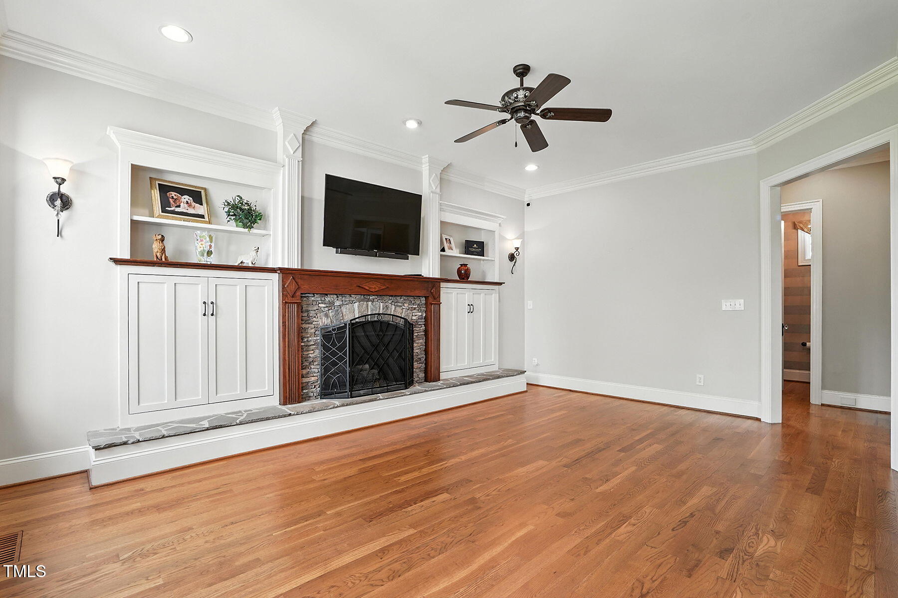 1605 Hunting Ridge Road Raleigh, NC 27615 - Photo 17 of 55 a view of a livingroom with a fireplace a ceiling fan and windows