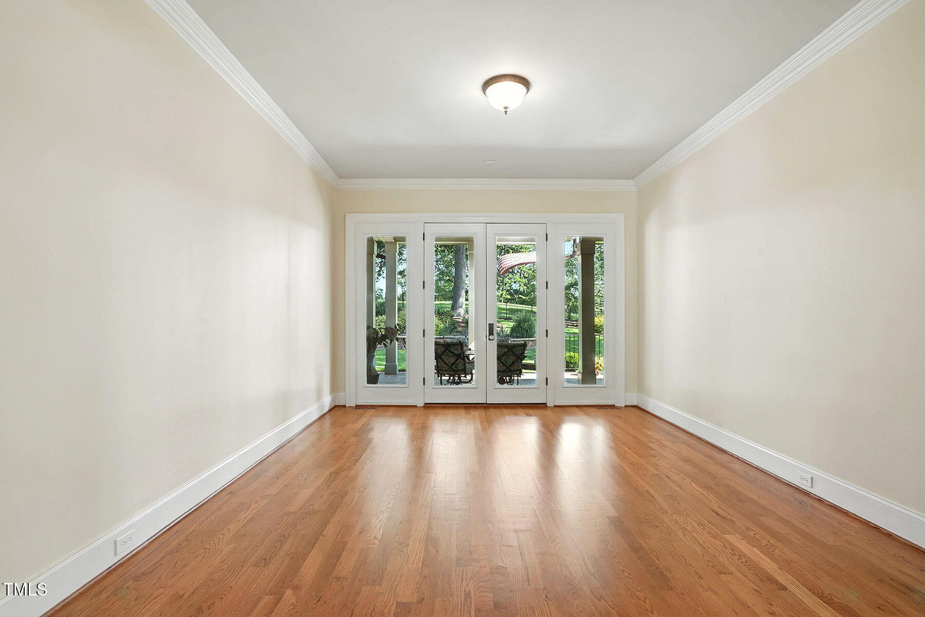 1605 Hunting Ridge Road Raleigh, NC 27615 - Photo 20 of 55 an empty room with wooden floor and windows
