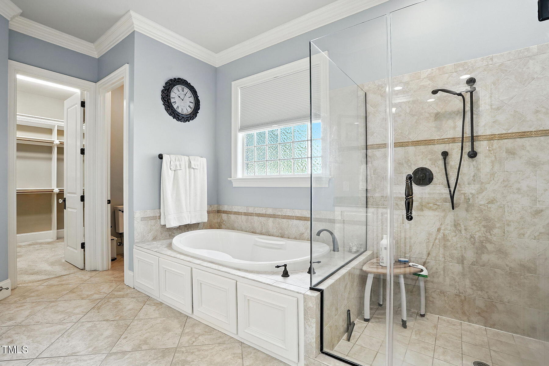 1605 Hunting Ridge Road Raleigh, NC 27615 - Photo 28 of 55 a bathroom with a tub a mirror and a shower