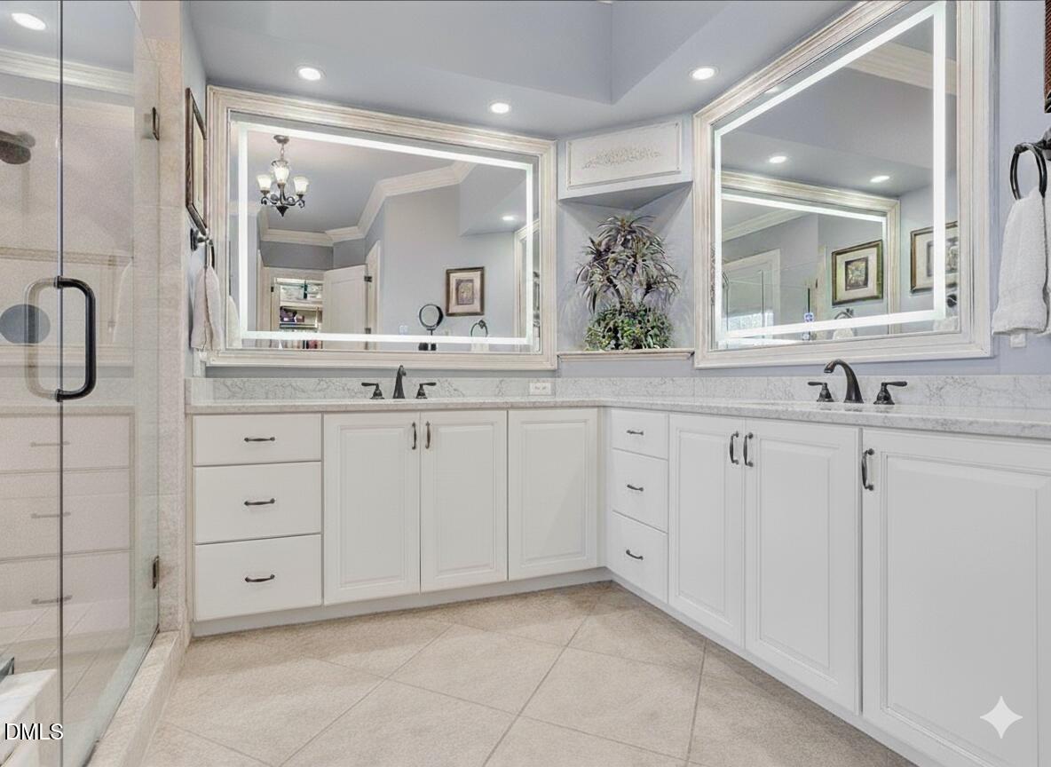 1605 Hunting Ridge Road Raleigh, NC 27615 - Photo 30 of 55 a bathroom with a granite countertop sink two mirror and a