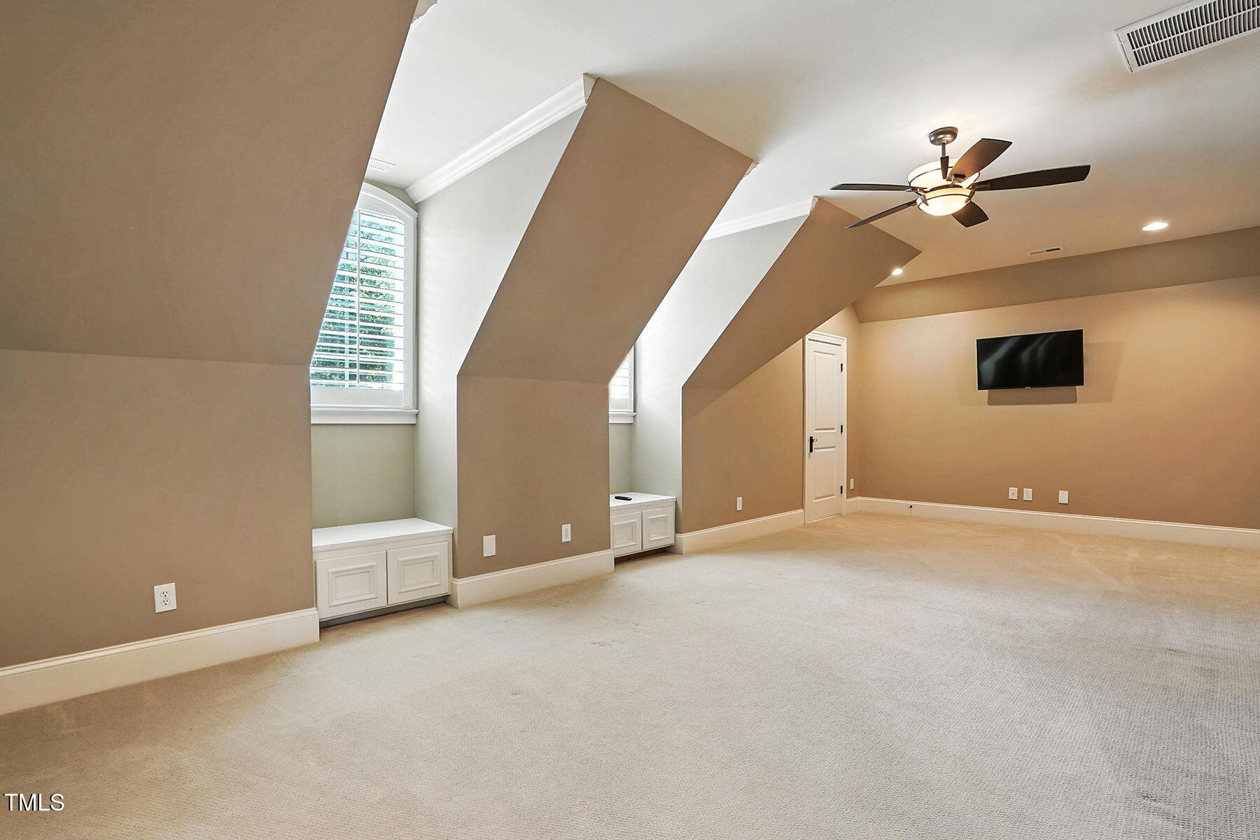 1605 Hunting Ridge Road Raleigh, NC 27615 - Photo 32 of 55 a view of an empty room with a ceiling fan
