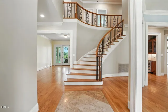 a view of entryway and hall with wooden floor