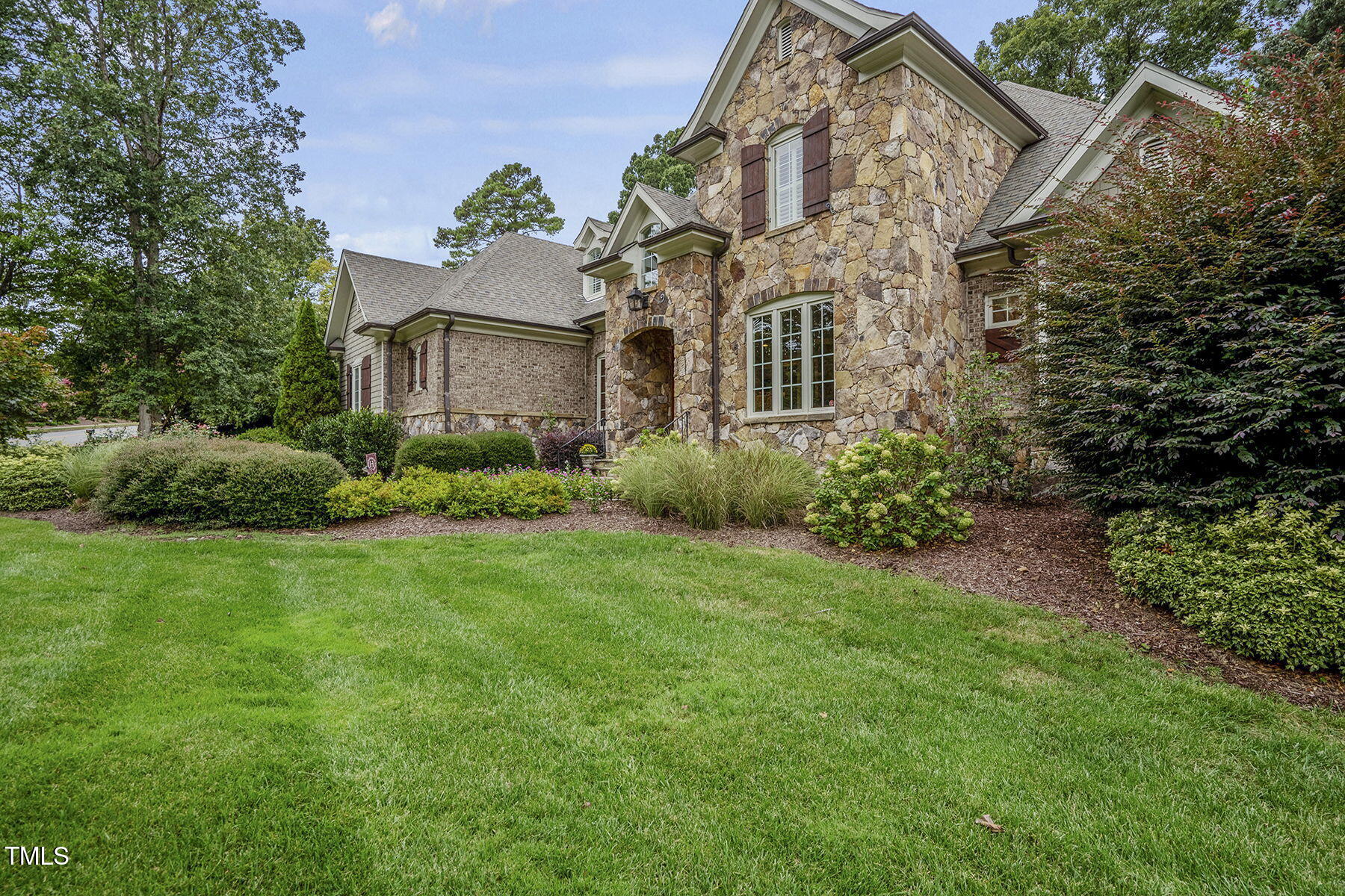 1605 Hunting Ridge Road Raleigh, NC 27615 - Photo 54 of 55 a view of a big yard in front of a house with plants and large trees