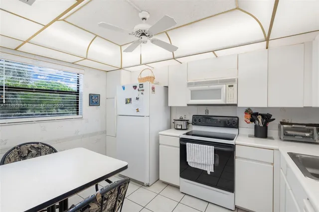 a kitchen with stainless steel appliances kitchen island a stove a sink and a refrigerator