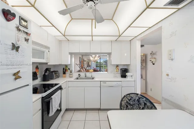 a kitchen with a sink dishwasher a stove and a refrigerator with wooden floor