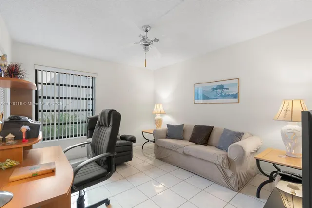 a living room with furniture a rug and a window