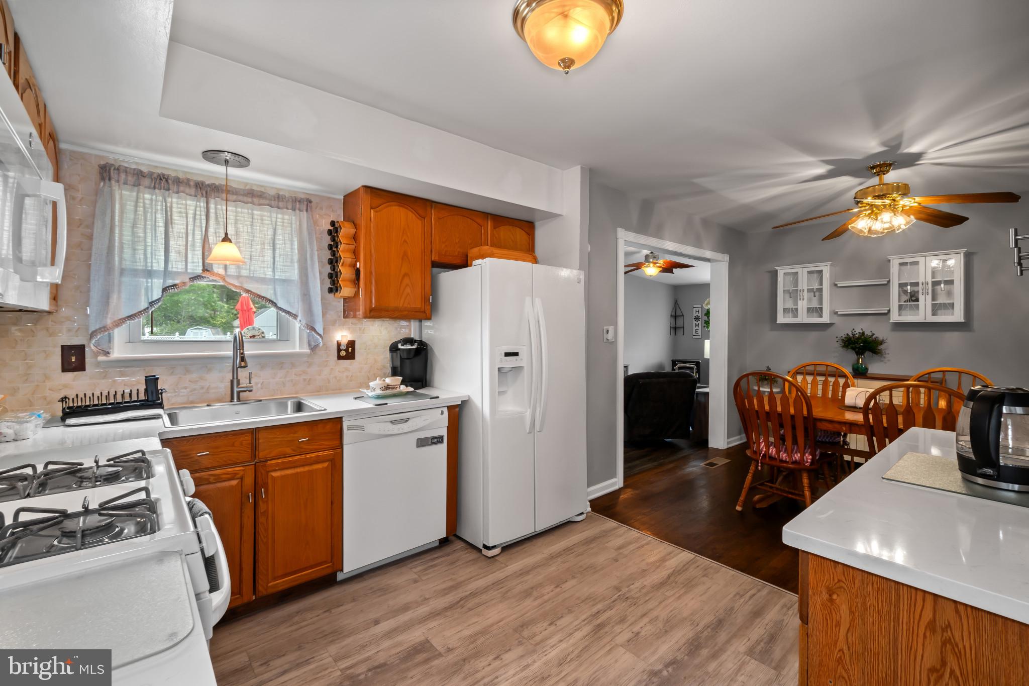 407 Bowleys Quarters Road Baltimore, MD 21220 - Photo 8 of 38 a kitchen with stainless steel appliances granite countertop a stove a sink dishwasher and a refrigerator with wooden floor