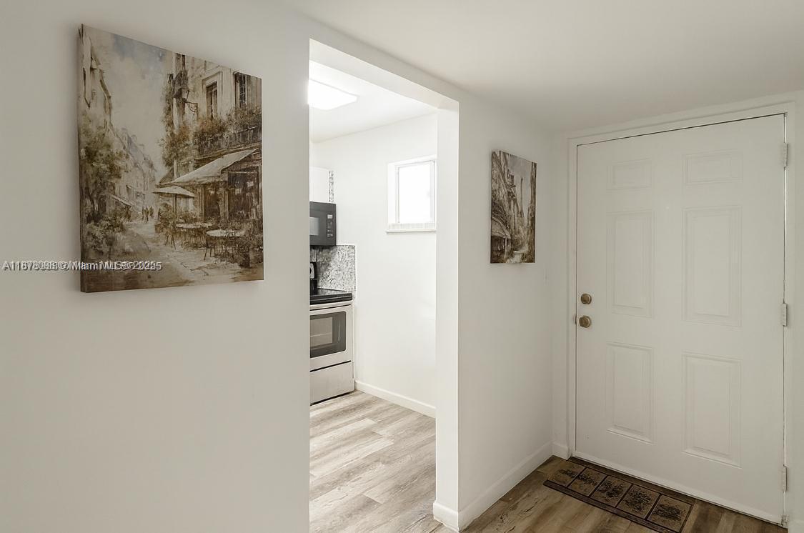 11301 Southwest 200th Street, Unit 306A Miami, FL 33157 - Photo 2 of 10 a view of a small space with wooden floor and closet