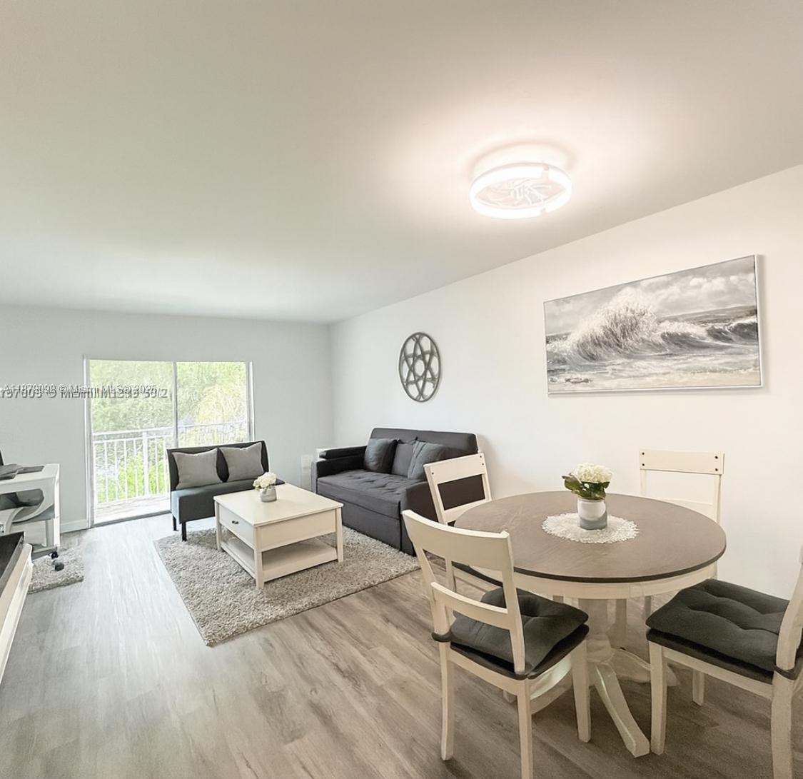 11301 Southwest 200th Street, Unit 306A Miami, FL 33157 - Photo 3 of 10 a living room with furniture and a wooden floor