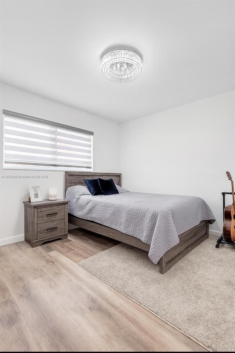 11301 Southwest 200th Street, Unit 306A Miami, FL 33157 - Photo 5 of 10 a bedroom with a bed and a couch