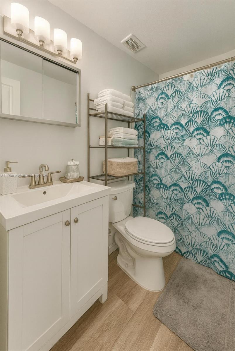 11301 Southwest 200th Street, Unit 306A Miami, FL 33157 - Photo 7 of 10 a bathroom with a sink toilet and shower