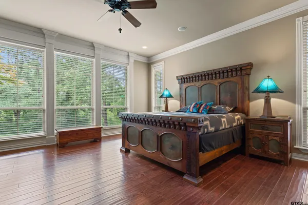 an aerial view of a houses with a yard and lake view