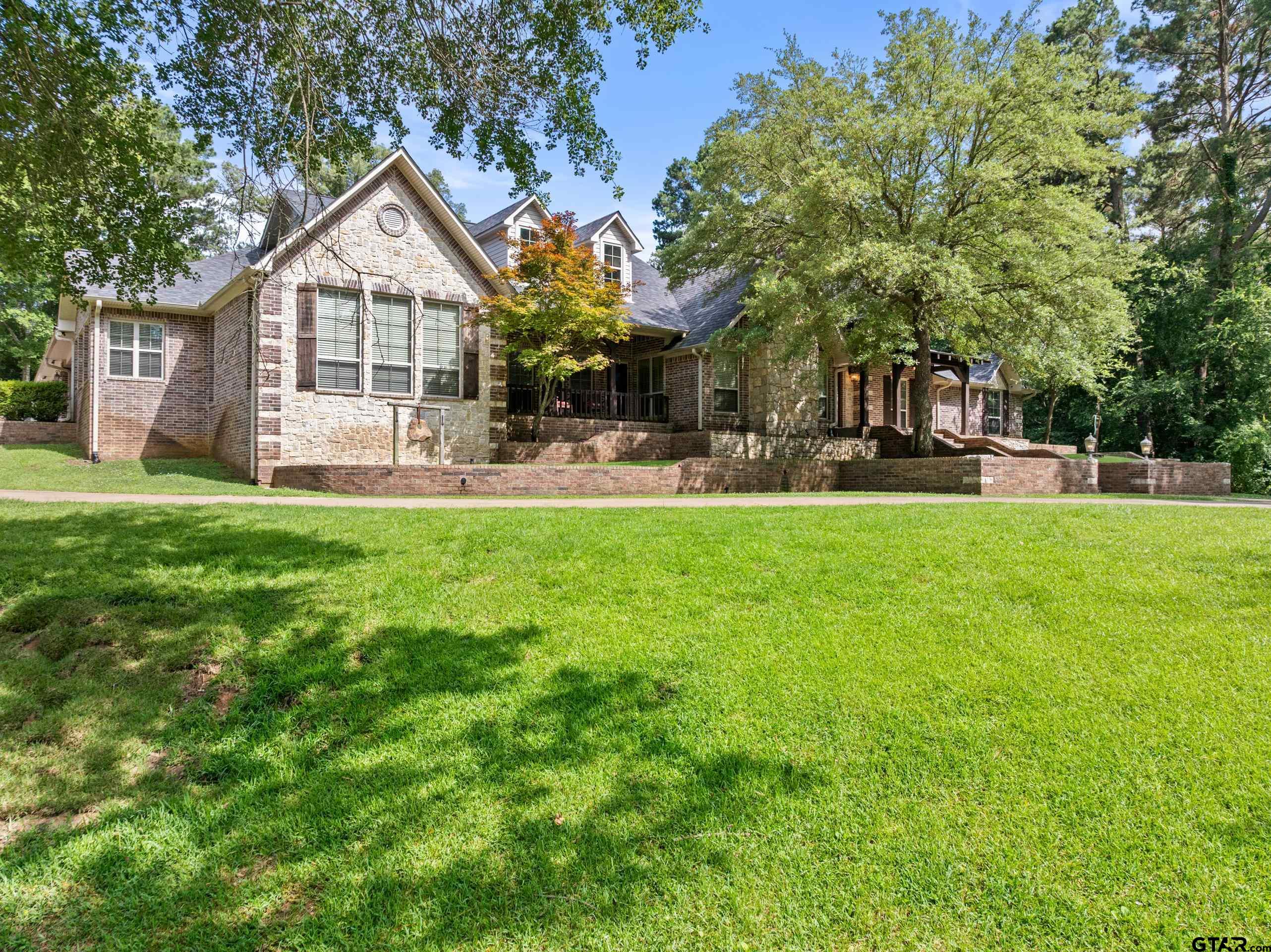 19678-c R 4125 C R 4125 Lindale, TX 75771 - Photo 42 of 48 a front view of a house with a garden and trees