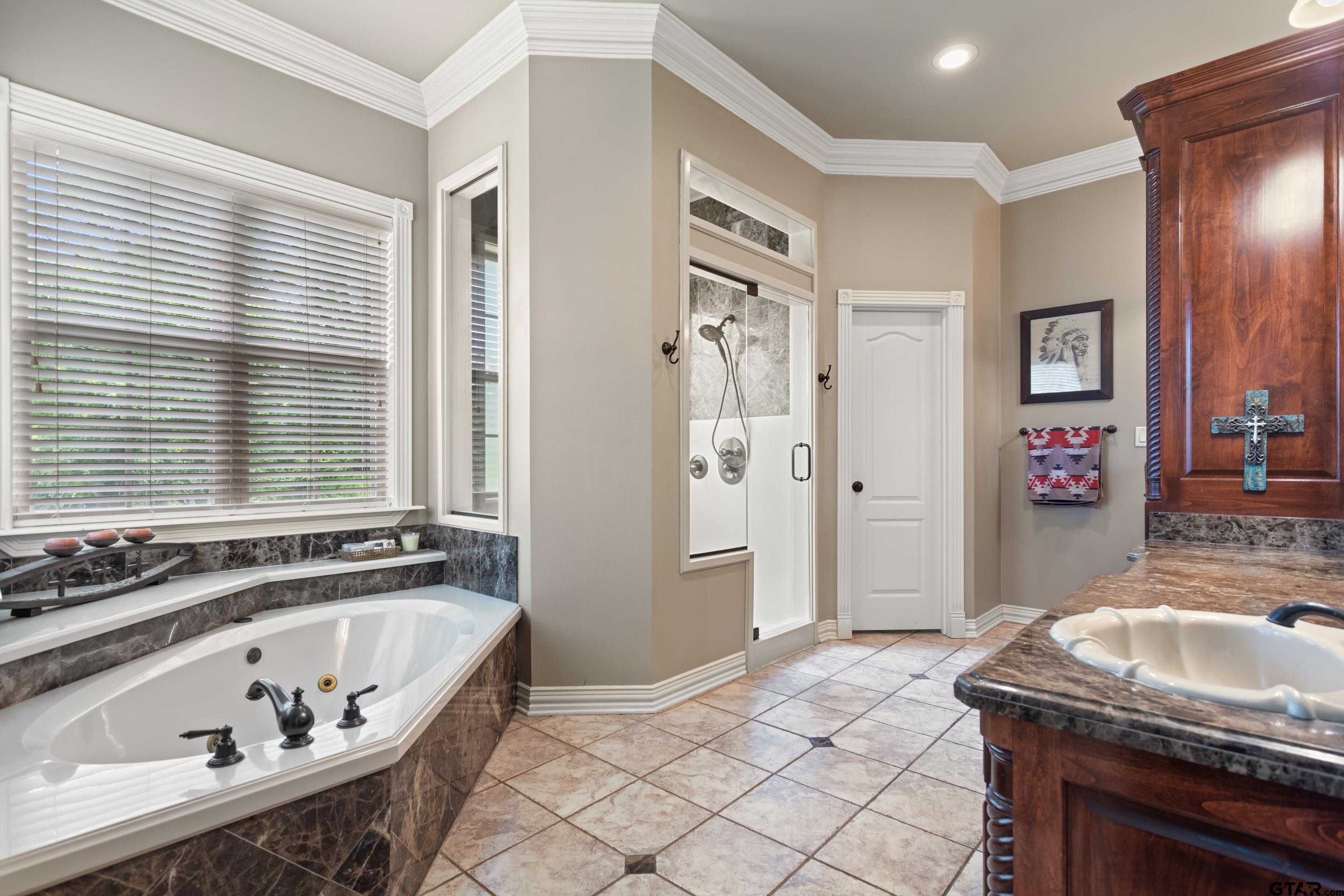 19678-c R 4125 C R 4125 Lindale, TX 75771 - Photo 5 of 48 a bathroom with a tub sink and mirror