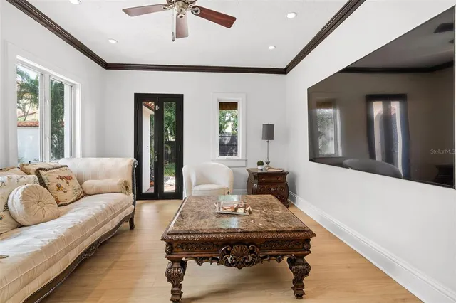 a view of a bedroom with wooden floor and a bed