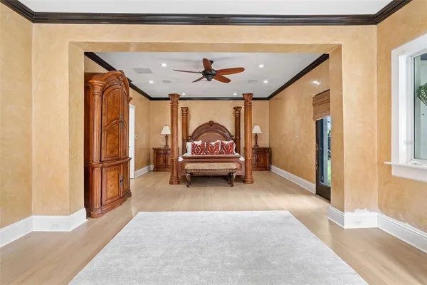 a bedroom with a bed next to a large window