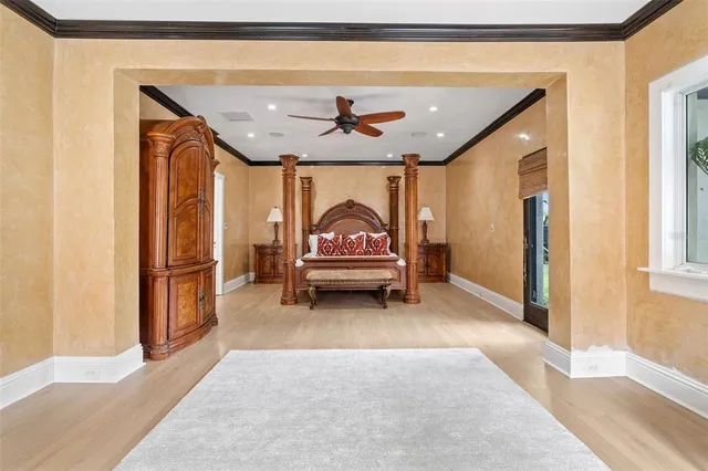 a bedroom with a bed next to a large window