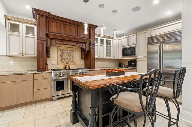 a kitchen with granite countertop a sink and appliances