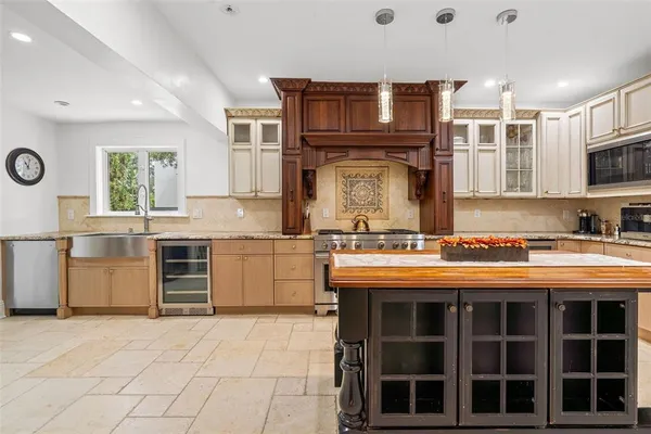 a kitchen with stainless steel appliances granite countertop a stove and a sink