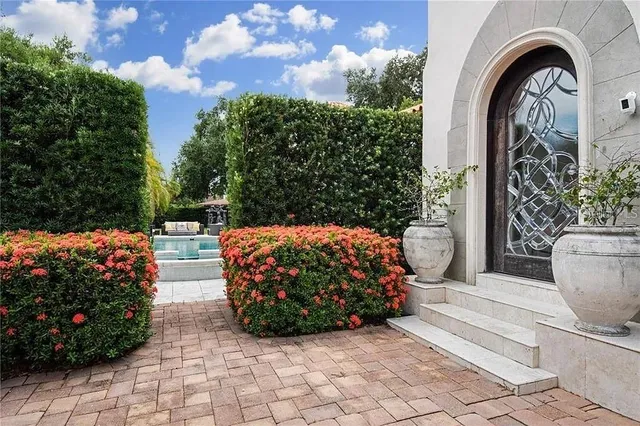 a view of a patio with couple of chairs and a fire pit