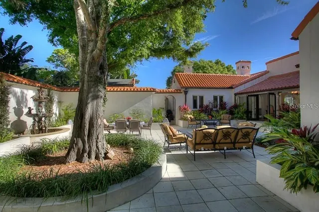 a view of a house with backyard and sitting area